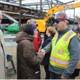 Representative Rosa DeLauro shaking the hand of a construction worker at a construction site.