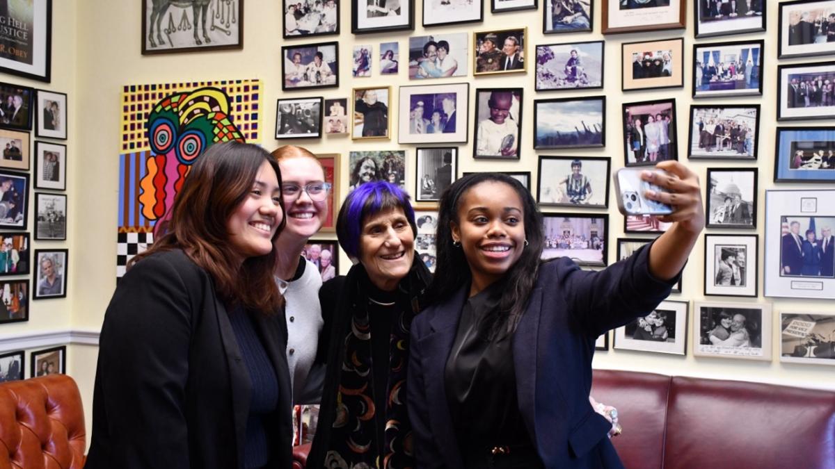 Rosa DeLauro takes a selfie with her interns smiling.